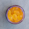 Jar of orange pickles on a gray surface