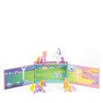 Set of colorful unicorn figurines with a miniature landscape scene on a white background