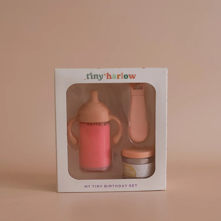 Baby bottle and teether set in Tiny Harlow packaging on a beige background