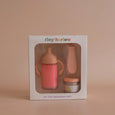 Baby bottle and teether set in Tiny Harlow packaging on a beige background