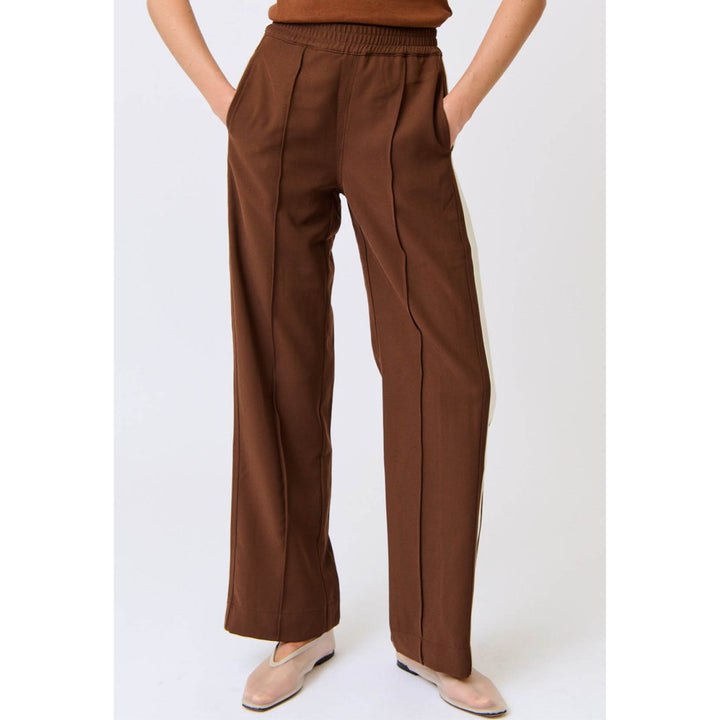 Brown pants worn by a person on a white background
